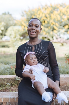 Excyna holding her baby, Linda